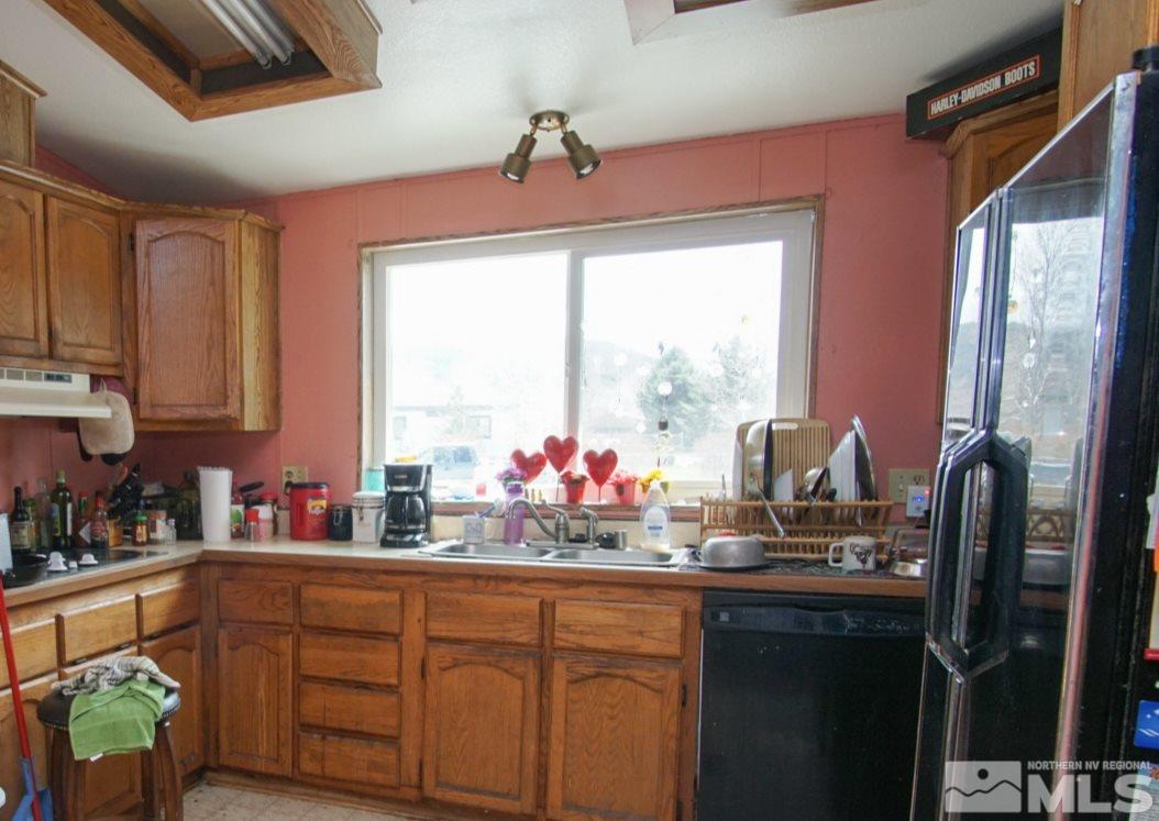 17355 Sunbird Lane Reno, NV 89508 - Photo 4 of 11 a kitchen with sink a window and cabinets
