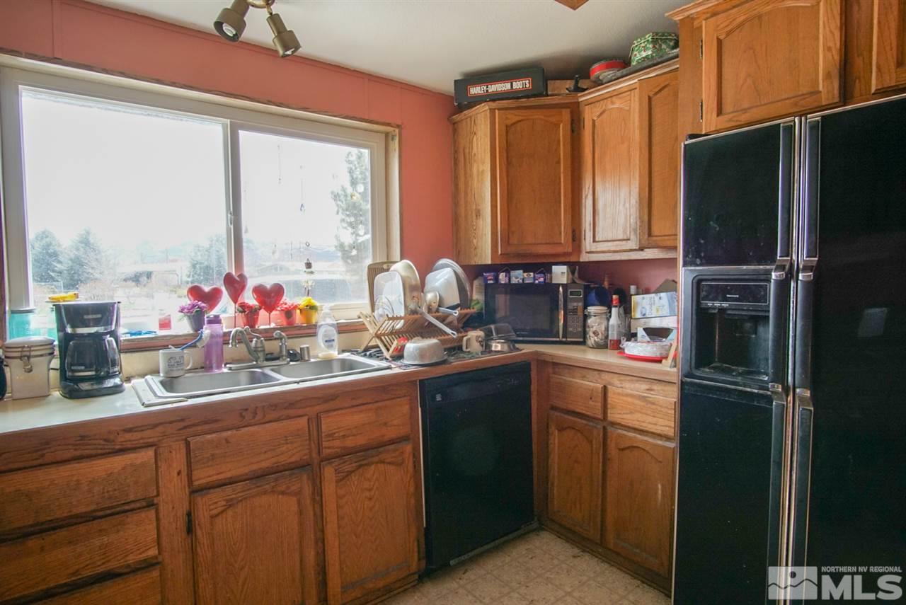 17355 Sunbird Lane Reno, NV 89508 - Photo 6 of 11 a kitchen with appliances a sink and a counter top space