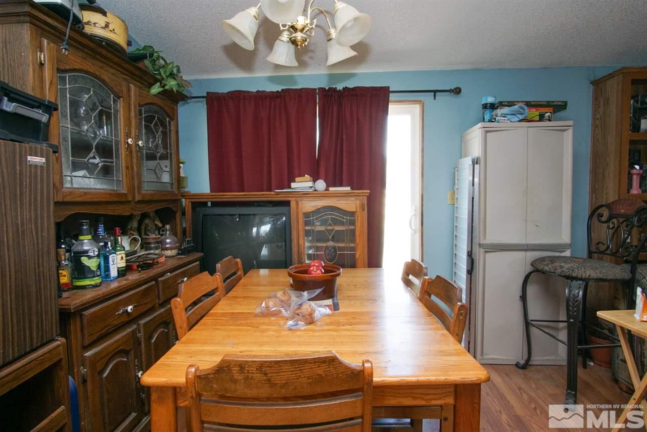 17355 Sunbird Lane Reno, NV 89508 - Photo 7 of 11 a dining room with wooden floor furniture and a refrigerator