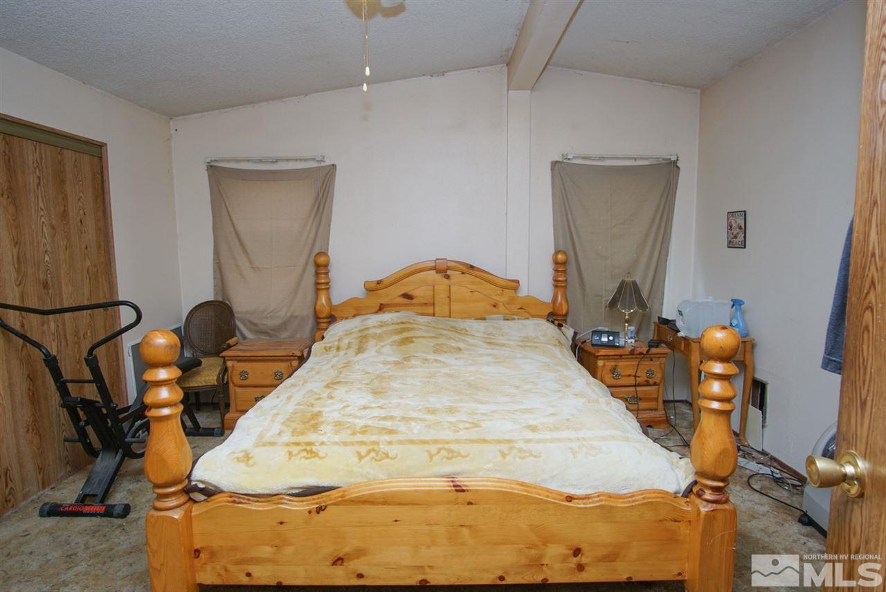 17355 Sunbird Lane Reno, NV 89508 - Photo 8 of 11 a bedroom with a bed and wooden floor
