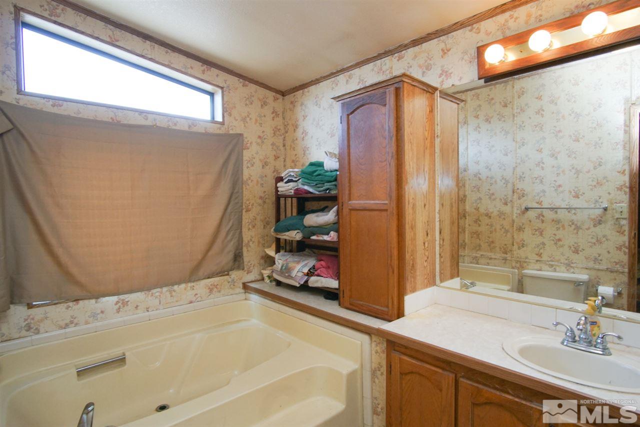 17355 Sunbird Lane Reno, NV 89508 - Photo 9 of 11 a bathroom with a tub sink and a mirror