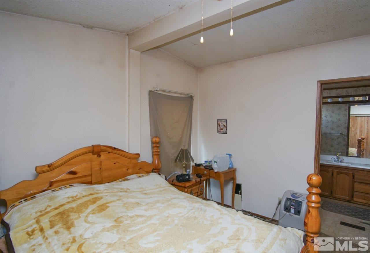 17355 Sunbird Lane Reno, NV 89508 - Photo 10 of 11 a bedroom with a bed and a table in it
