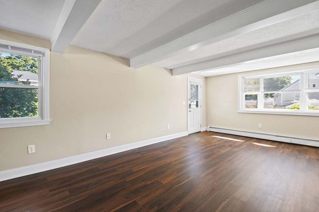 3 Matthew Road Billerica, MA 01821 - Photo 11 of 41 a view of an empty room with wooden floor and a window
