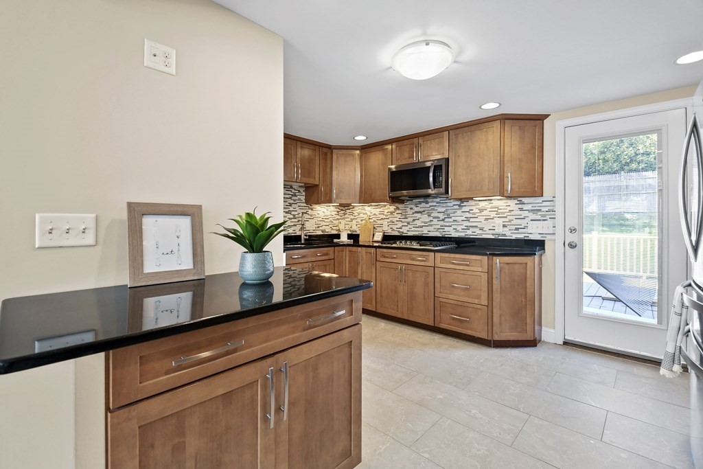 3 Matthew Road Billerica, MA 01821 - Photo 12 of 41 a kitchen with stainless steel appliances granite countertop a stove a sink and a refrigerator