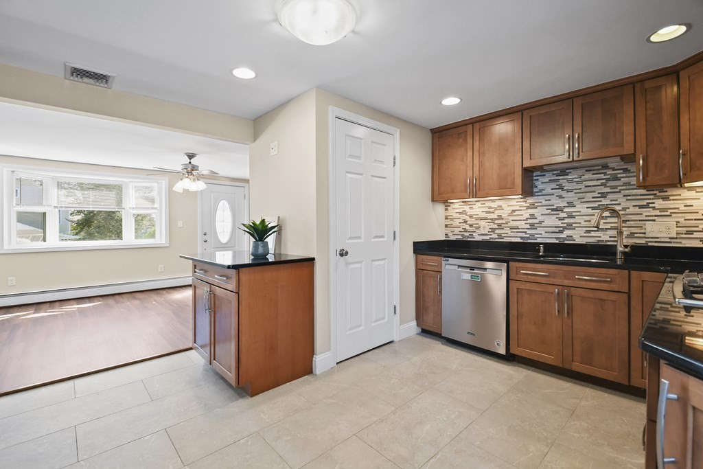 3 Matthew Road Billerica, MA 01821 - Photo 14 of 41 a kitchen with stainless steel appliances granite countertop a refrigerator a sink a stove a microwave and island