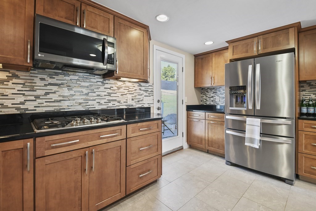 3 Matthew Road Billerica, MA 01821 - Photo 16 of 41 a kitchen with stainless steel appliances granite countertop a refrigerator stove and microwave