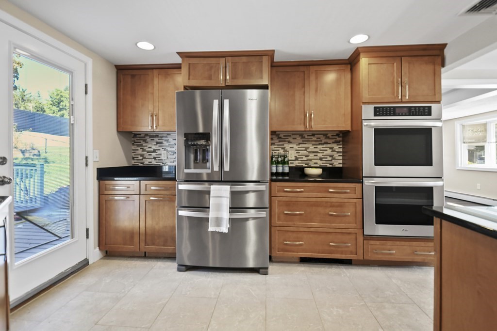 3 Matthew Road Billerica, MA 01821 - Photo 17 of 41 a kitchen with stainless steel appliances kitchen island granite countertop a refrigerator oven stove a sink and dishwasher