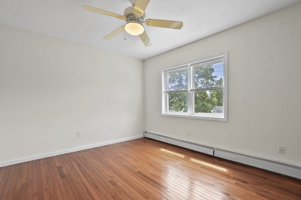 3 Matthew Road Billerica, MA 01821 - Photo 24 of 41 an empty room with wooden floor and windows