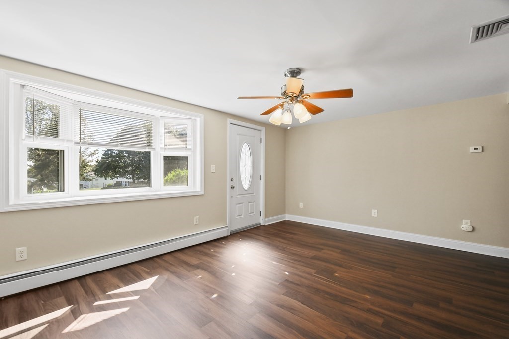 3 Matthew Road Billerica, MA 01821 - Photo 6 of 41 a view of an empty room with wooden floor and a window