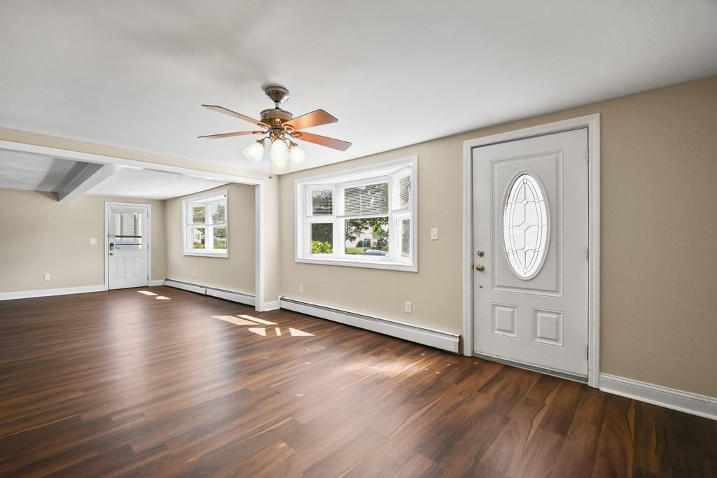 3 Matthew Road Billerica, MA 01821 - Photo 7 of 41 an empty room with wooden floor chandelier fan and windows