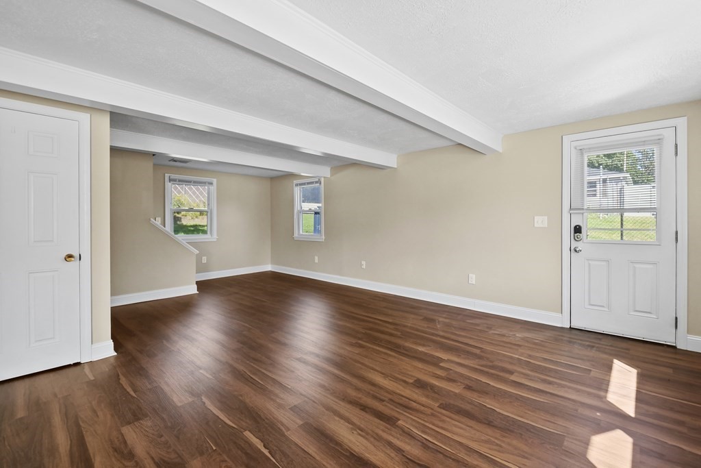 3 Matthew Road Billerica, MA 01821 - Photo 9 of 41 an empty room with wooden floor and windows
