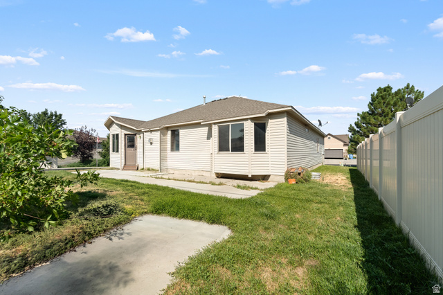 3396 Carmy Road Magna, UT 84044 - Photo 22 of 32 Single-story residence featuring light-colored siding, a brown shingle roof, and a bay window