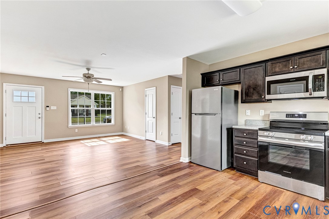 9925 Reymet Court Richmond, VA 23237 - Photo 8 of 30 a view of kitchen with stainless steel appliances wooden floor and window
