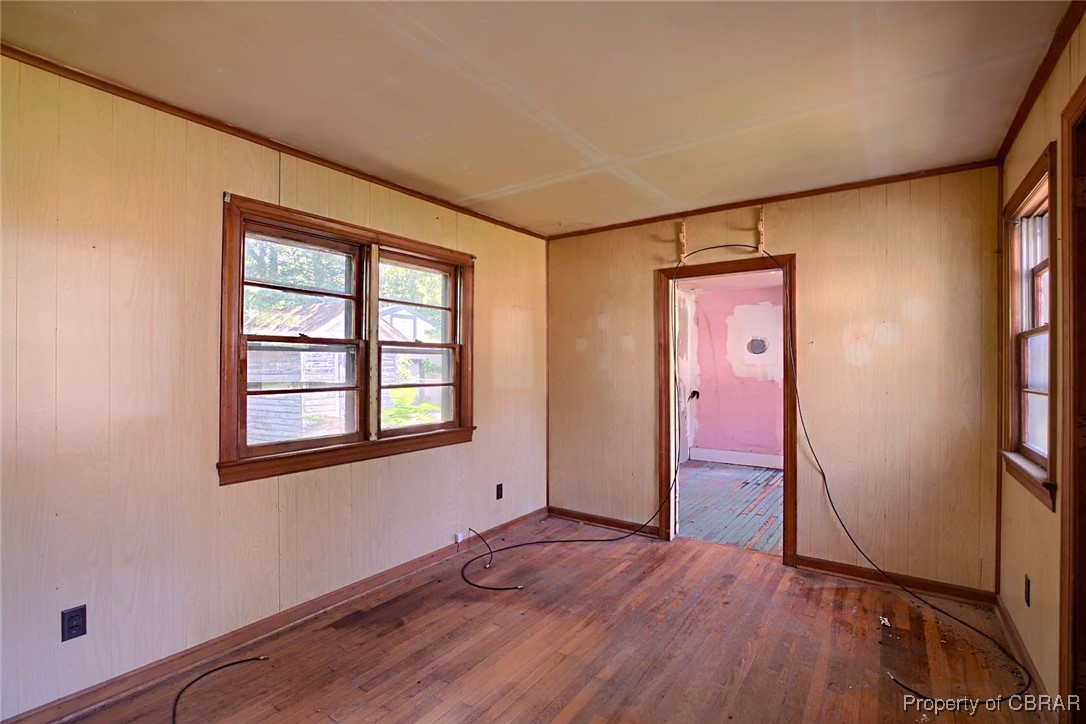 708 Calthrop Neck Road Yorktown, VA 23693 - Photo 18 of 24 Unfurnished room featuring wood-type flooring and ornamental molding