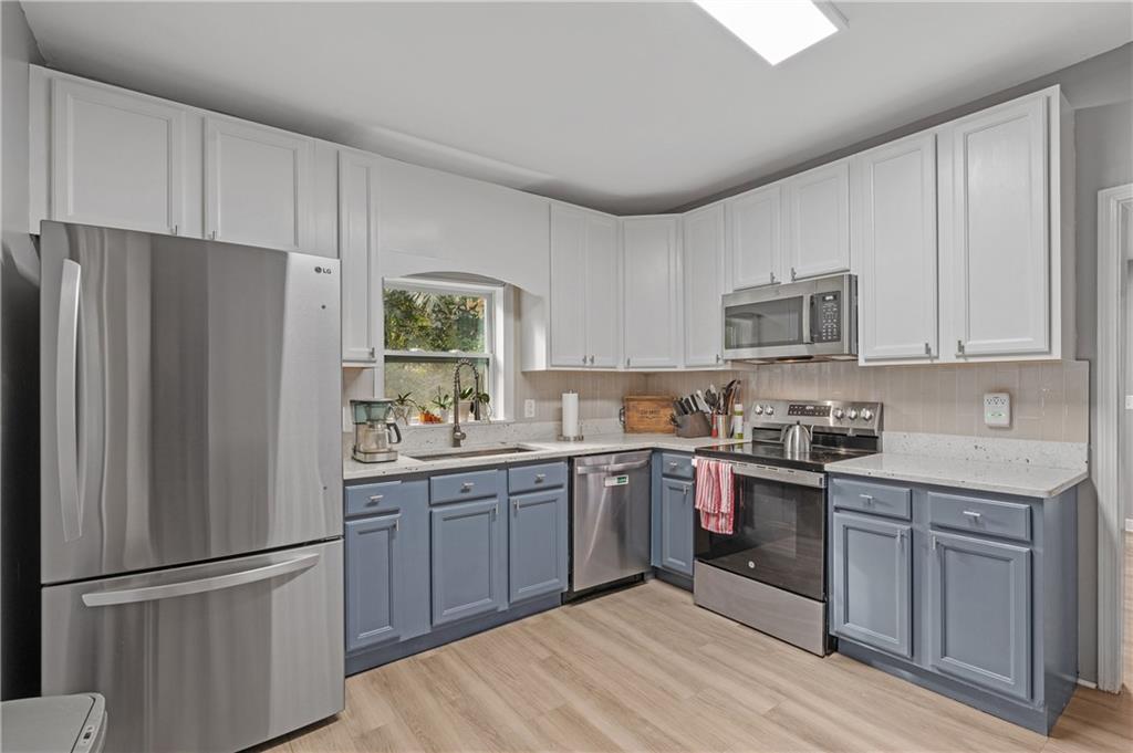 4748 Fowler Circle Acworth, GA 30101 - Photo 11 of 27 a kitchen with white cabinets stainless steel appliances and a window