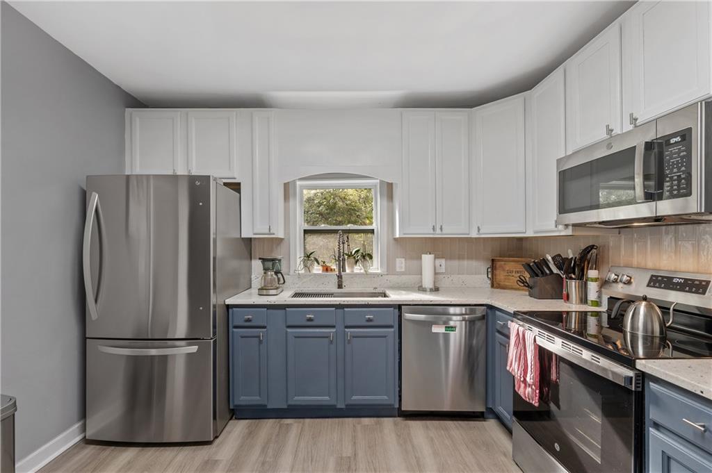 4748 Fowler Circle Acworth, GA 30101 - Photo 13 of 27 a kitchen with stainless steel appliances a refrigerator stove and sink