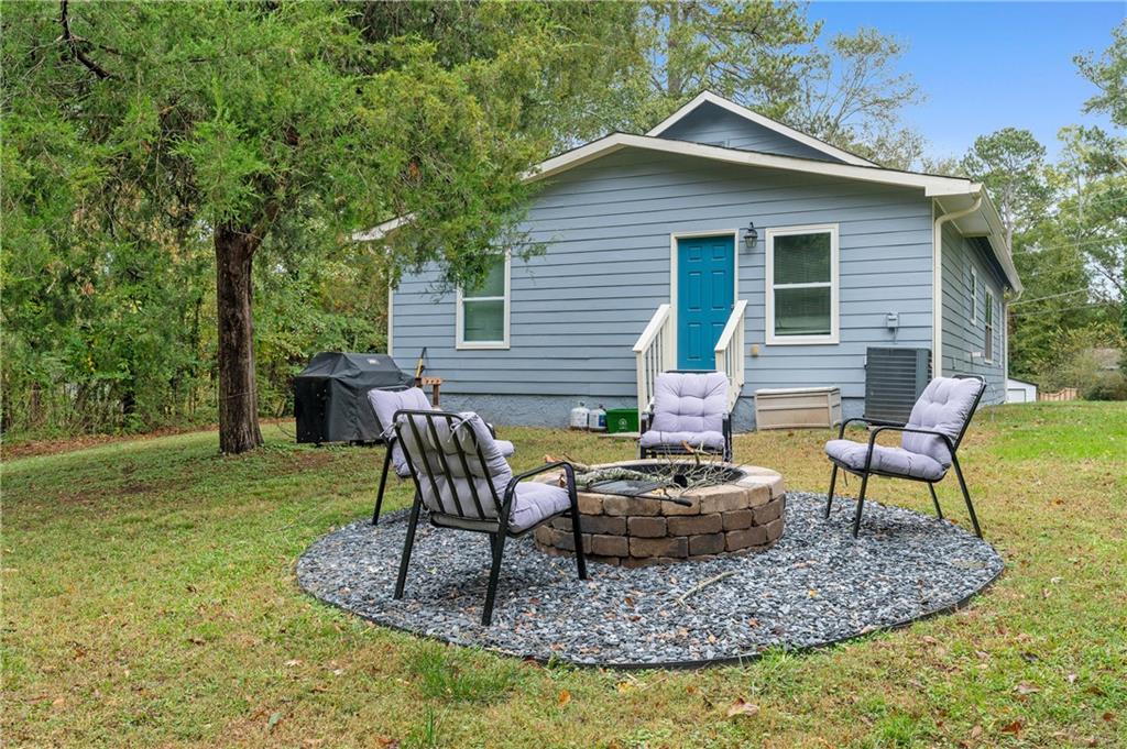 4748 Fowler Circle Acworth, GA 30101 - Photo 25 of 27 a view of a house with backyard sitting area and garden