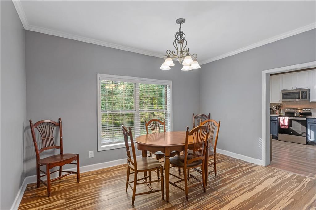 4748 Fowler Circle Acworth, GA 30101 - Photo 9 of 27 a view of a dining room with furniture wooden floor and chandelier