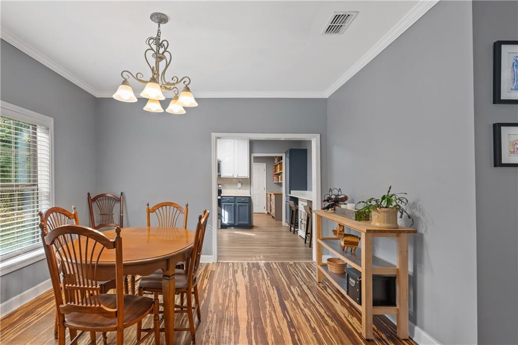 4748 Fowler Circle Acworth, GA 30101 - Photo 10 of 27 a dining room with furniture a chandelier and wooden floor