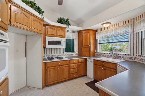 a kitchen that has a sink and a stove in it