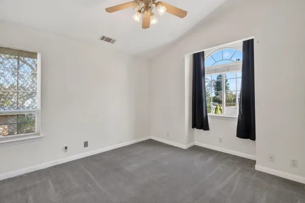an empty room with windows and closet