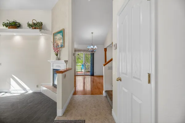 a view of hallway with livingroom and hallway with wooden floor