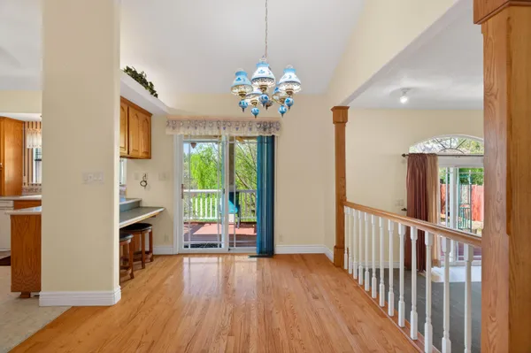 a view of a livingroom with furniture wooden floor fireplace and windows