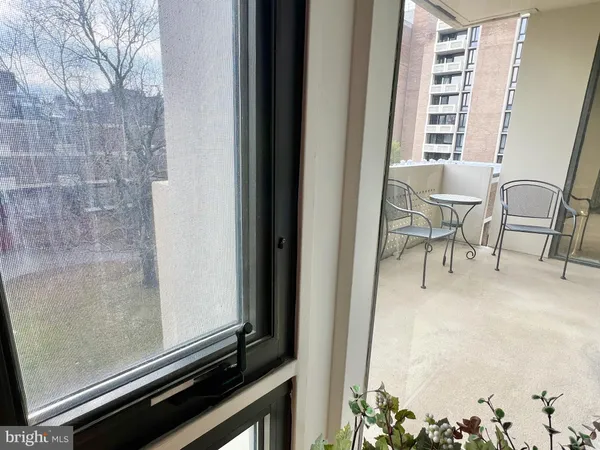 a view of a room with chairs and a window