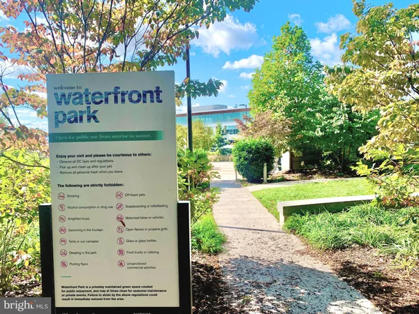 a street sign on a sidewalk next to a road
