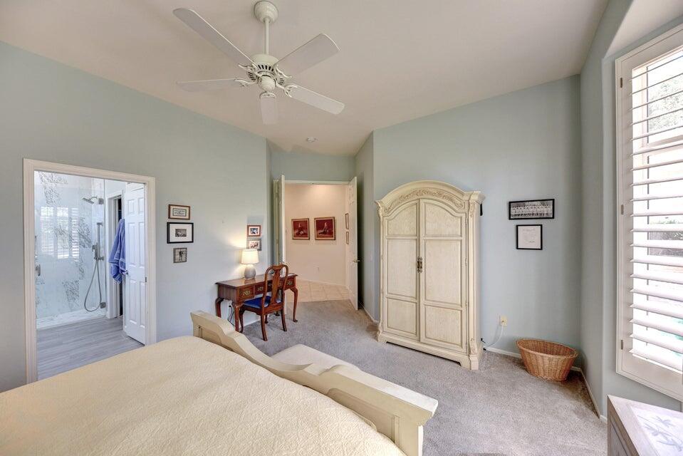 35841 Rosemont Drive Palm Desert, CA 92211 - Photo 14 of 22 a bedroom with a bed and a chandelier