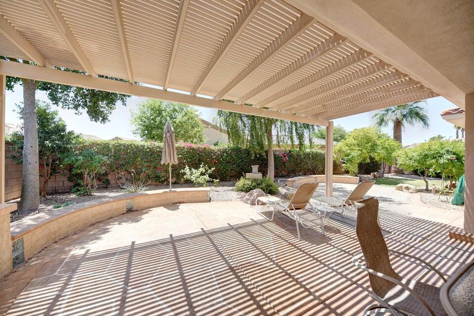 35841 Rosemont Drive Palm Desert, CA 92211 - Photo 19 of 22 a view of a patio with a table and chairs under an umbrella