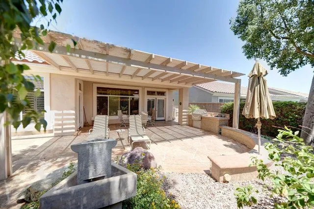 a view of a patio with couches chairs and potted plants