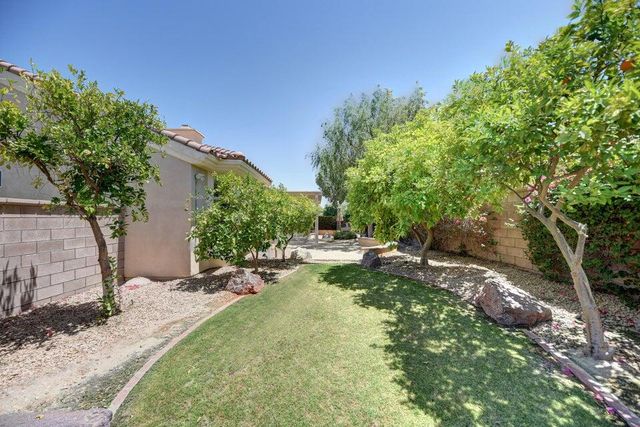 a backyard of a house with a table and chairs