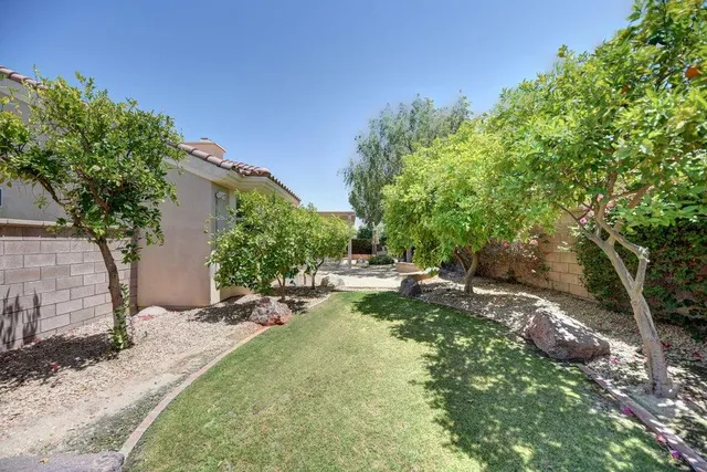 a backyard of a house with a table and chairs