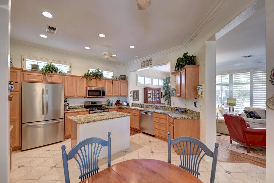 35841 Rosemont Drive Palm Desert, CA 92211 - Photo 7 of 22 a kitchen with granite countertop stainless steel appliances a refrigerator a stove a dining table and chairs