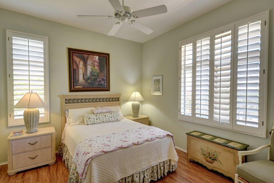 35841 Rosemont Drive Palm Desert, CA 92211 - Photo 10 of 22 a bedroom with a bed and wooden floor