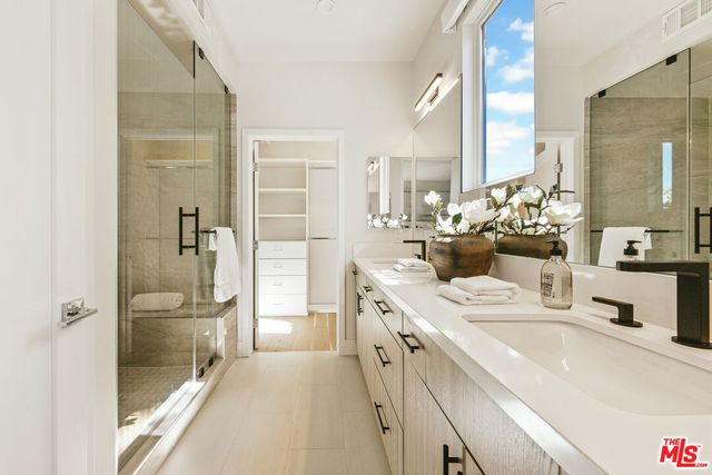 a large white kitchen with a large window