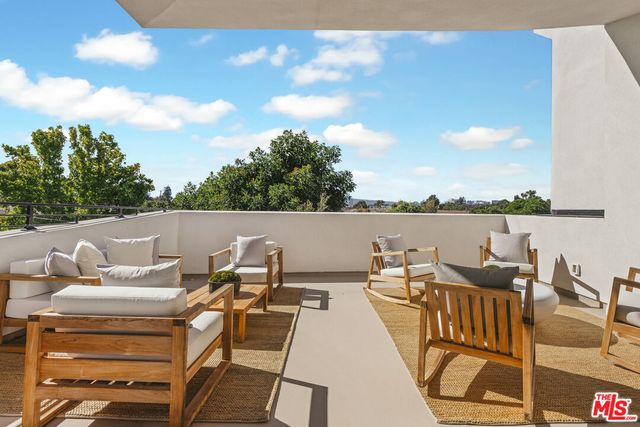 a terrace with outdoor seating and city view