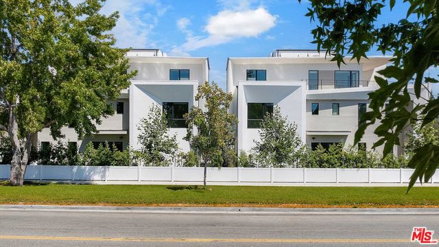 a view of white house with a swimming pool and a yard