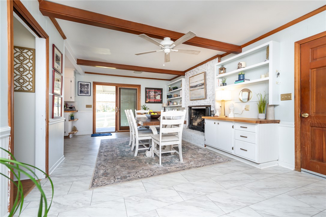 401 South Glassy Mountain Road Pickens, SC 29671 - Photo 22 of 37 This inviting dining area features elegant tile flooring and a cozy fireplace, perfect for intimate gatherings.
