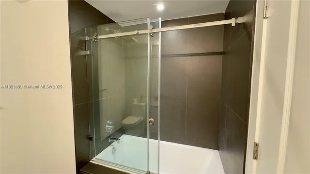 a bathroom with a glass shower door