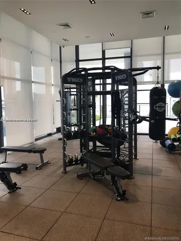 a room with gym equipment and a large window