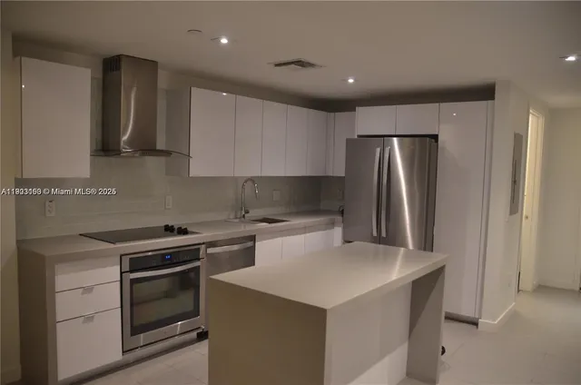 a kitchen with a stove a refrigerator and a sink