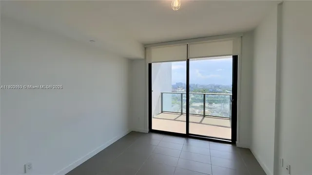 a view of an empty room with glass door