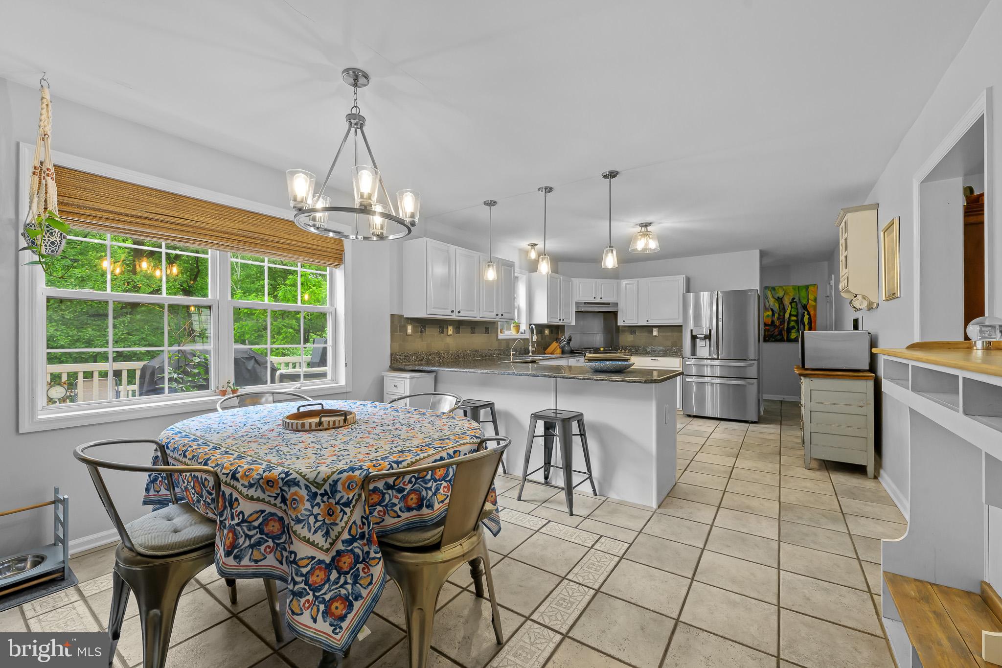 168 Sawmill Road Landenberg, PA 19350 - Photo 53 of 53 a open kitchen with granite countertop a table chairs sink and cabinets