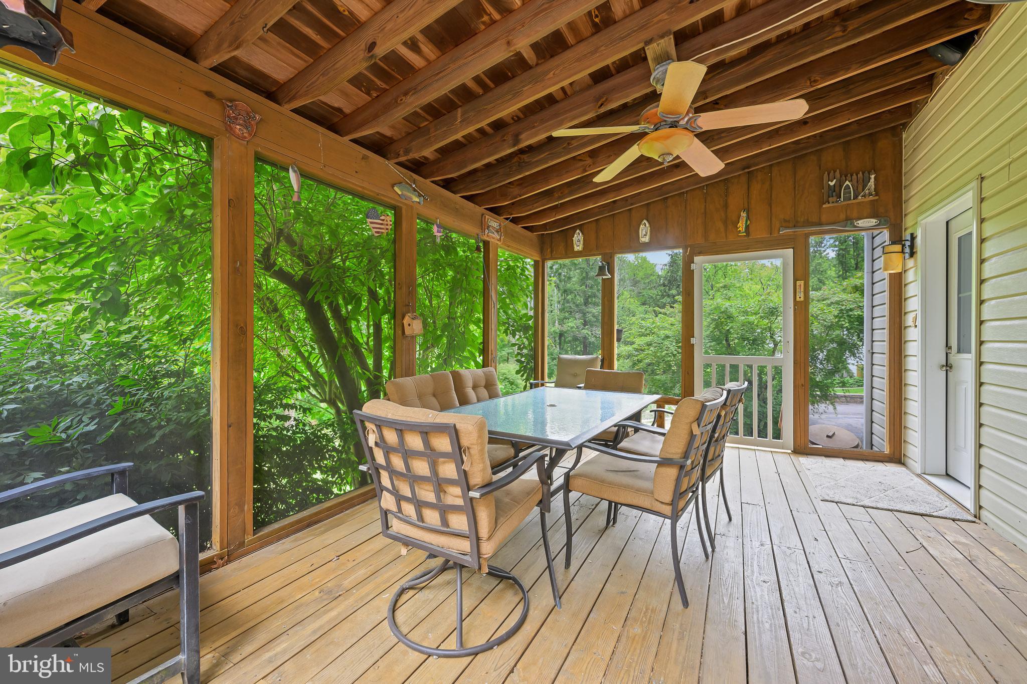 168 Sawmill Road Landenberg, PA 19350 - Photo 39 of 53 a view of a patio with a table chairs and wooden floor
