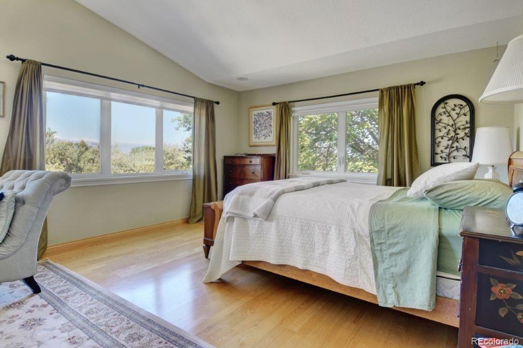 7856 Baseline Road Boulder, CO 80303 - Photo 14 of 40 a bedroom with a bed chair and a large window