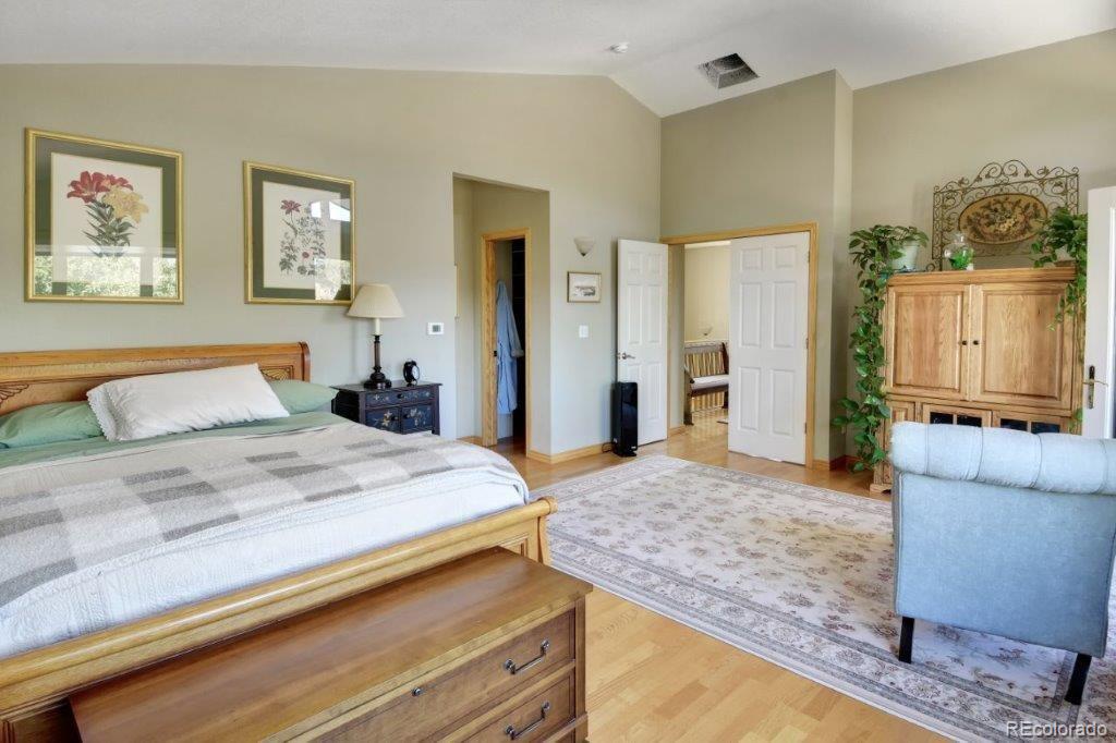 7856 Baseline Road Boulder, CO 80303 - Photo 15 of 40 a spacious bedroom with a bed and a couch