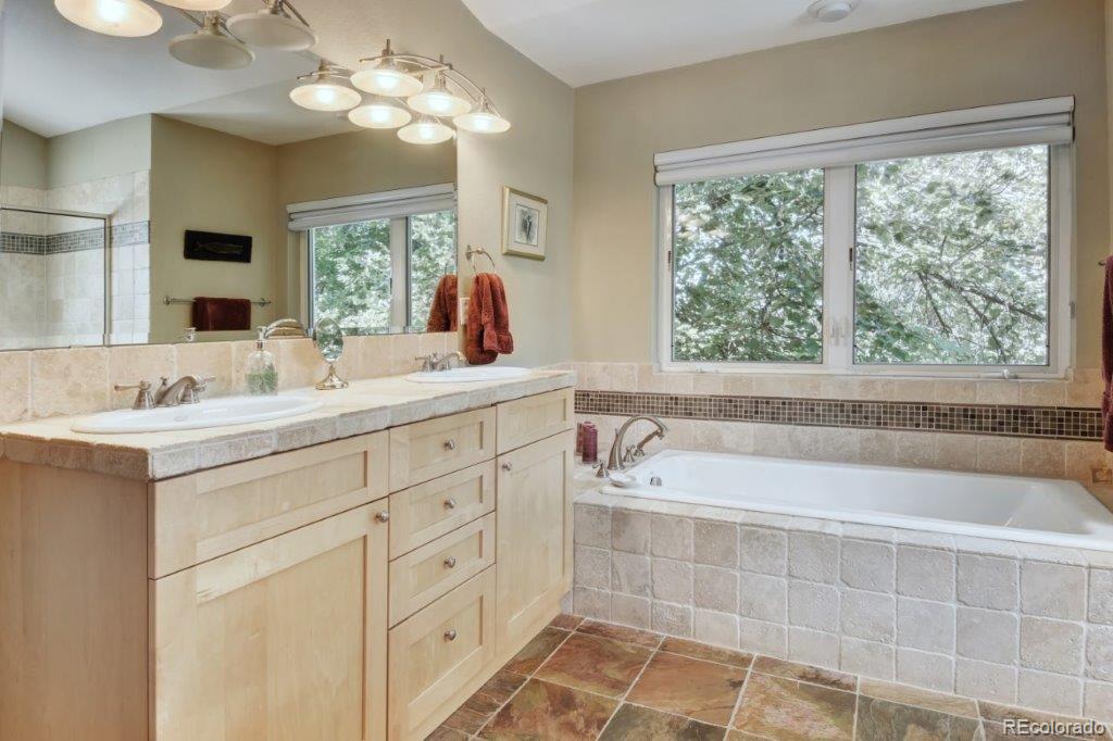 7856 Baseline Road Boulder, CO 80303 - Photo 16 of 40 a bathroom with a tub a sink and a window