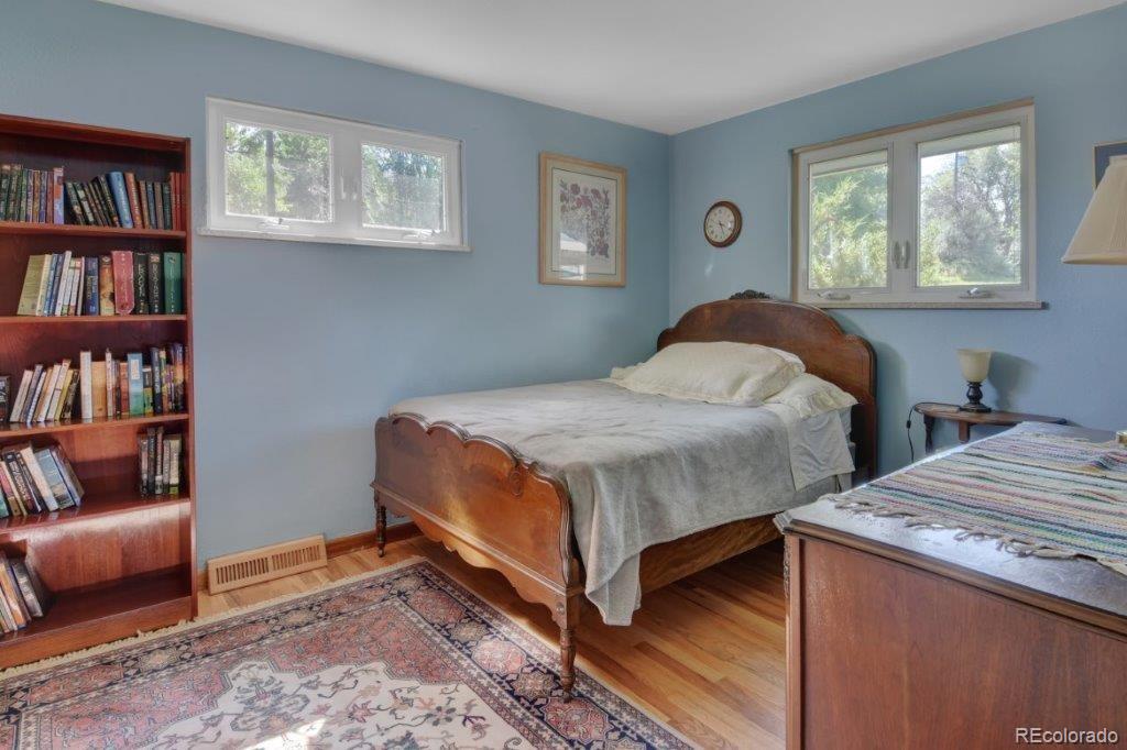 7856 Baseline Road Boulder, CO 80303 - Photo 23 of 40 a bedroom with a bed and a book shelf